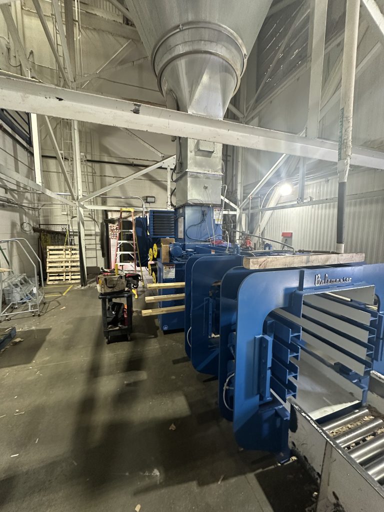 blue horizontal baler in warehouse